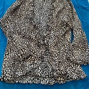 Sheer top that works great over a camisole. It ties in the middles.